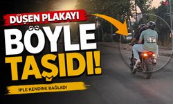 Ceza yememek için Motosiklet Plakasını Sırtına Bantladı